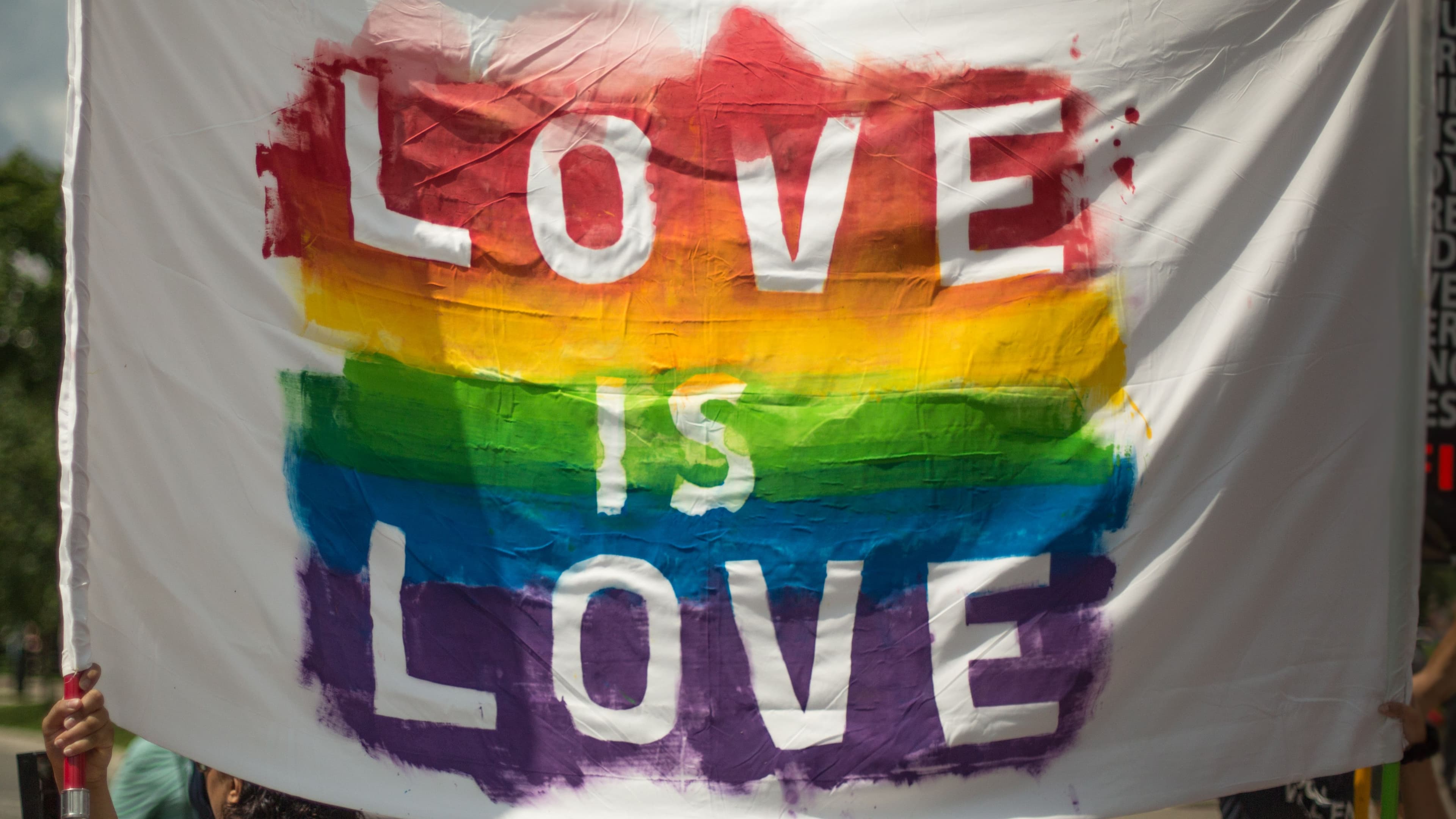 Pride flag detail used as a restrained LGBTQ+ visual accent