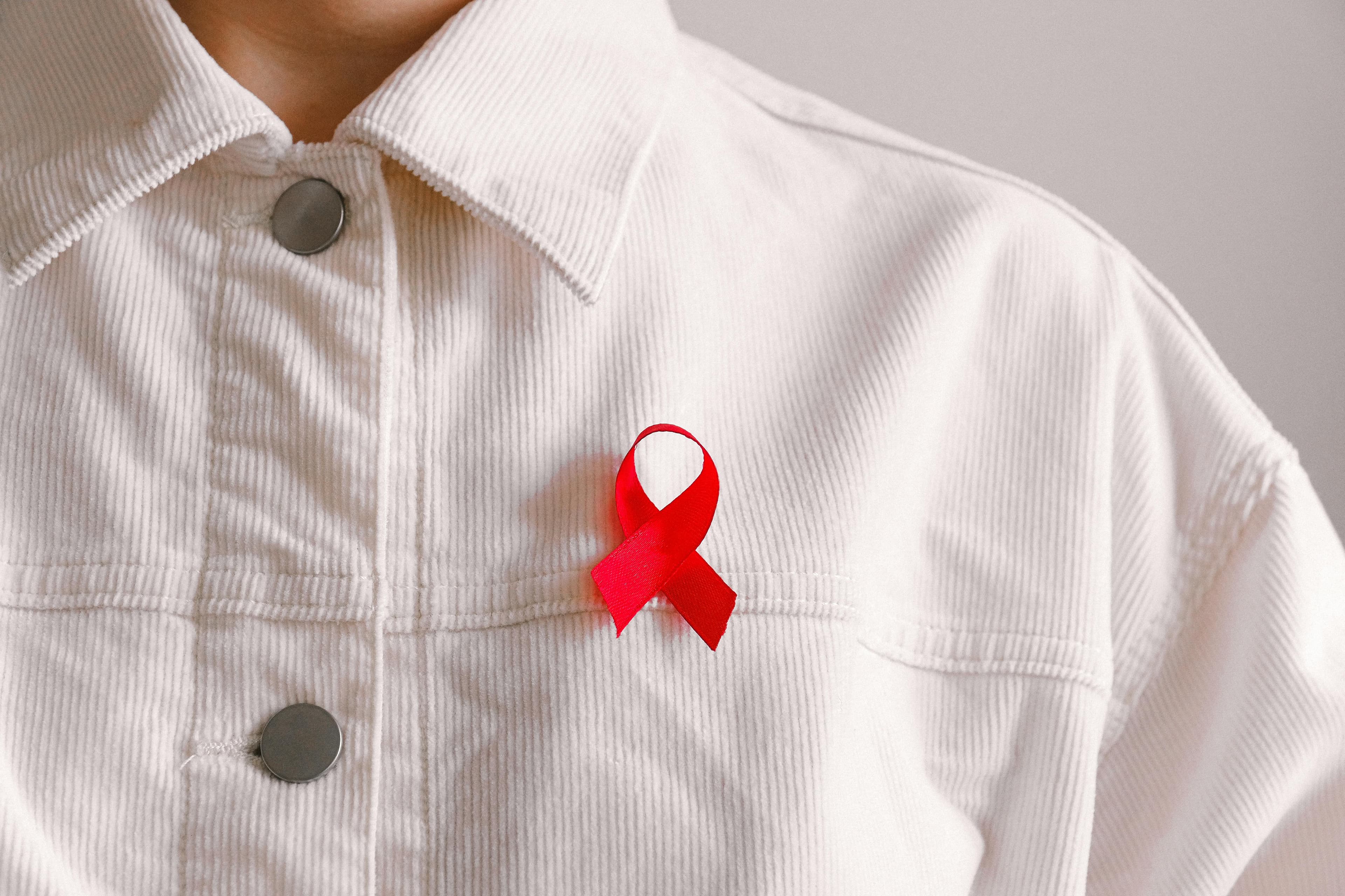 Red ribbon awareness image used for HIV-focused impact context
